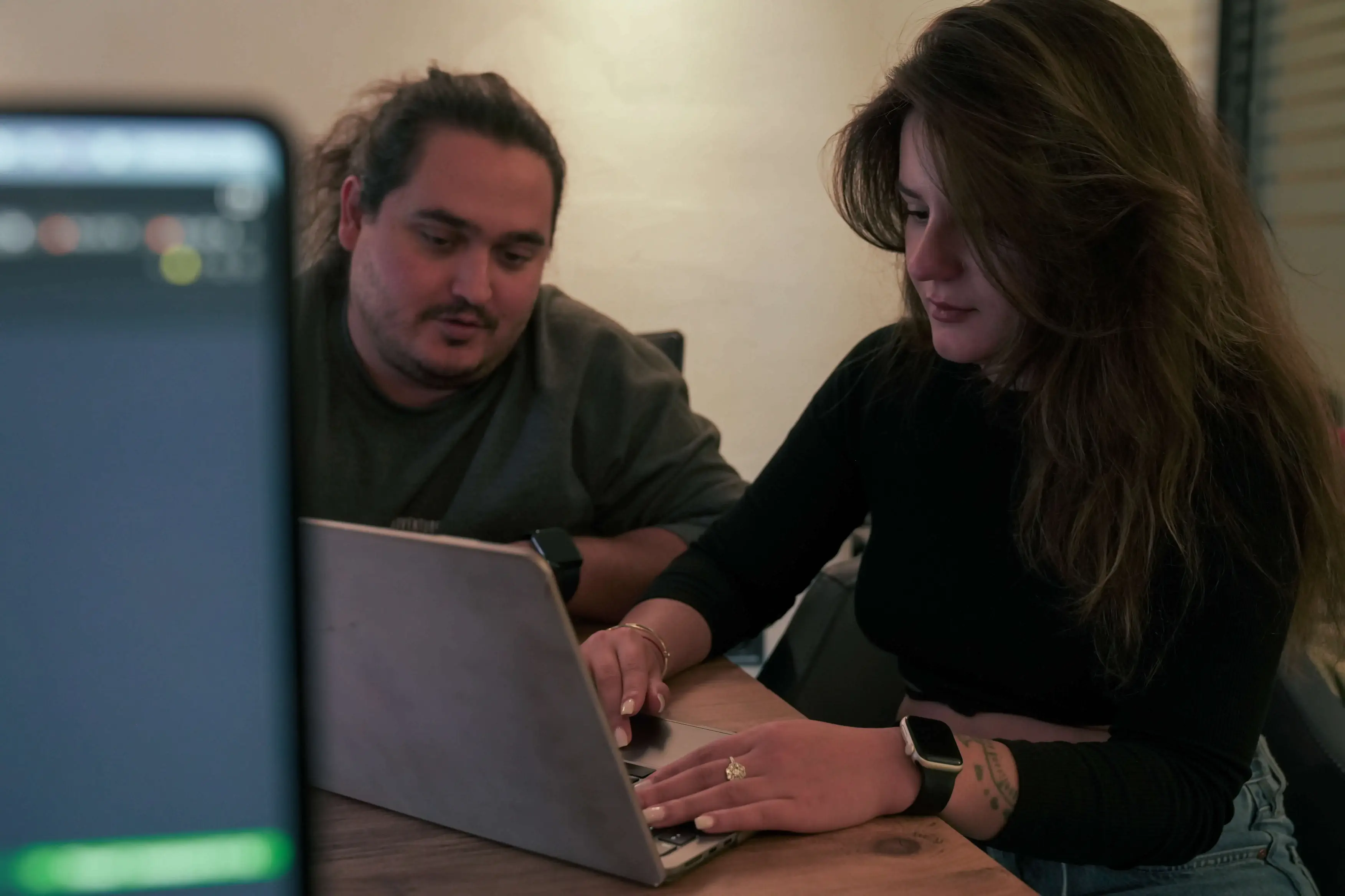 Two team members pairing at a laptop